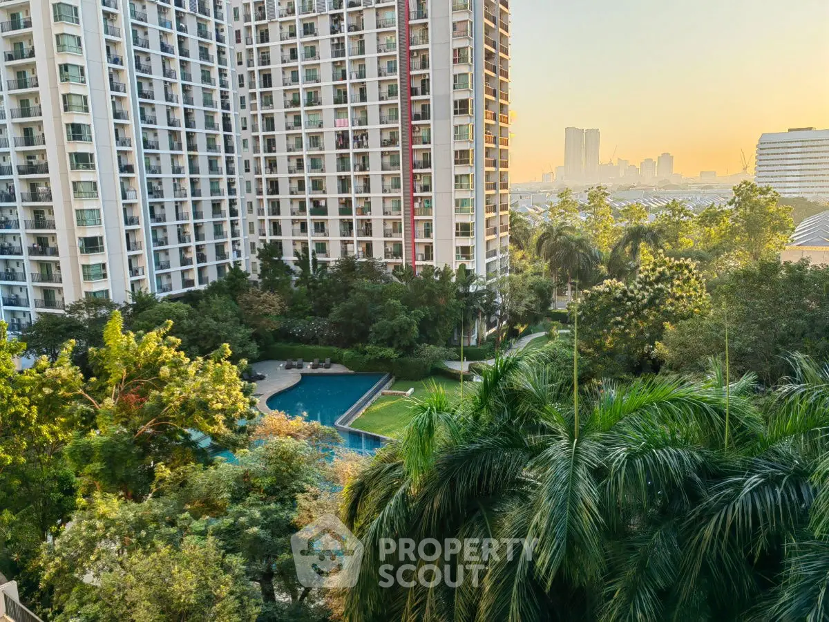 Stunning high-rise apartment with lush garden and pool view at sunset.