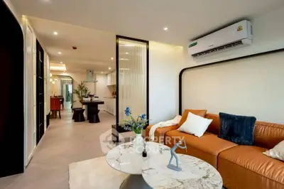 Modern living room with stylish decor and open layout, featuring cozy seating and elegant lighting.