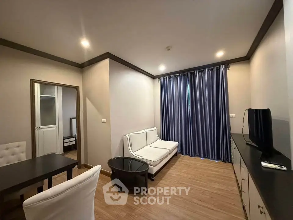 Modern living room with elegant furniture and wooden flooring in a cozy apartment.