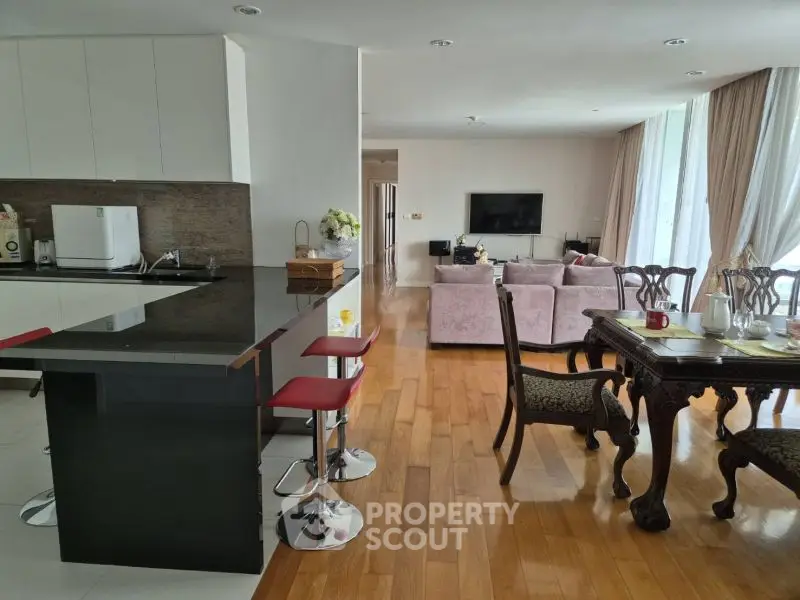 Spacious open-plan living room with modern kitchen and elegant dining area