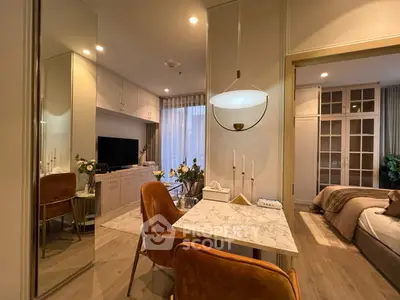 Elegant modern apartment interior with open living and dining area, featuring stylish decor and warm lighting.