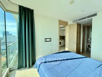 Modern bedroom with city view and balcony access in high-rise apartment