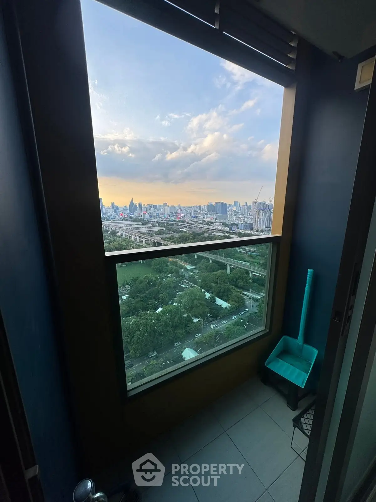 Stunning cityscape view from a high-rise balcony at sunset, perfect for urban living.