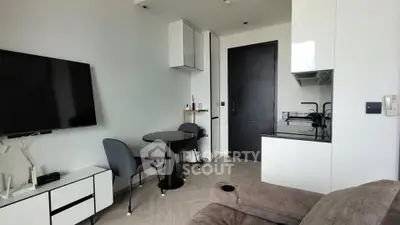 Modern living room with sleek furniture and wall-mounted TV in a stylish apartment.