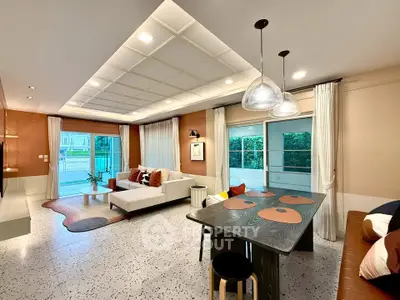 Modern living room with stylish decor and open layout, featuring a cozy seating area and dining space.