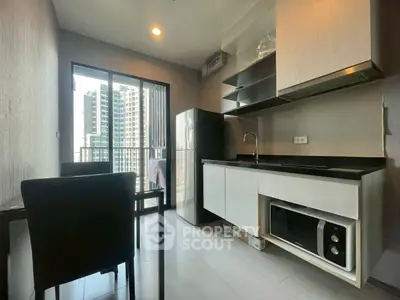 Modern kitchen with sleek cabinetry and city view from balcony