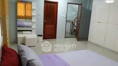 Spacious bedroom with modern decor and ample storage space