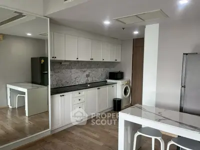 Modern kitchen with marble countertops and built-in appliances