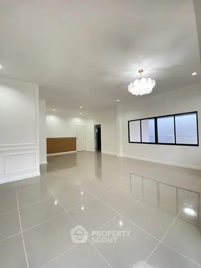 Spacious modern living room with elegant lighting and glossy tiled flooring