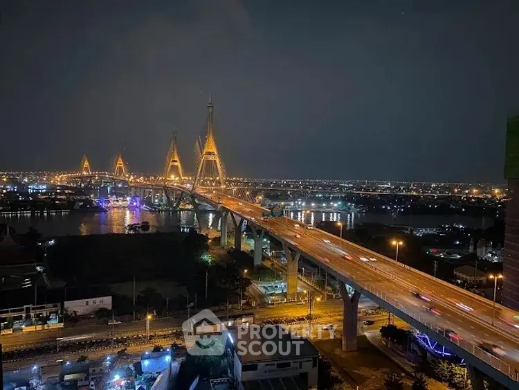 Stunning night view of illuminated bridge and cityscape, perfect for urban living enthusiasts.