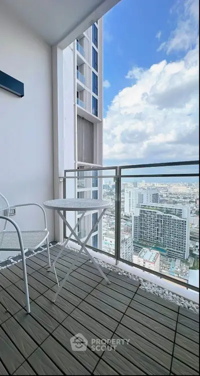 Stunning high-rise balcony with breathtaking city view and modern outdoor furniture.