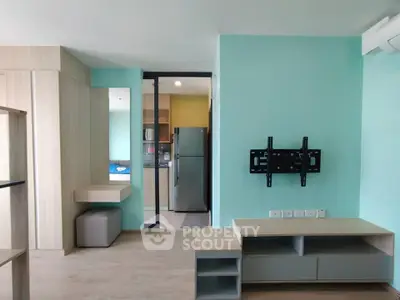 Modern apartment interior with mounted TV bracket and sleek kitchen view.