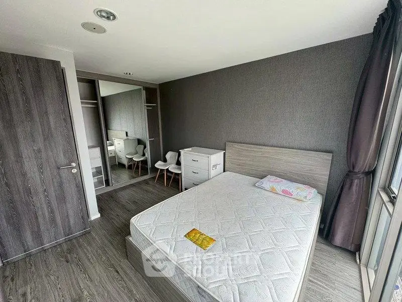 Modern bedroom with sleek design, featuring a comfortable bed, mirrored wardrobe, and stylish decor.