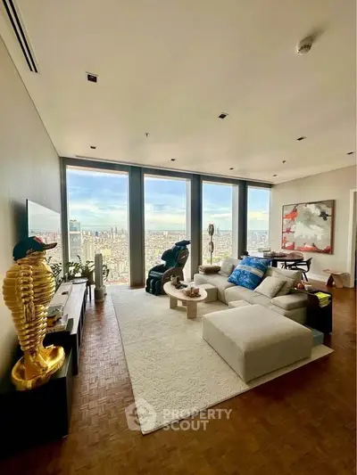 Luxurious living room with stunning city view, modern decor, and spacious seating area.