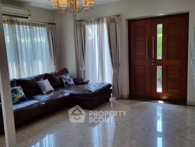 Spacious living room with elegant leather sofa and natural light