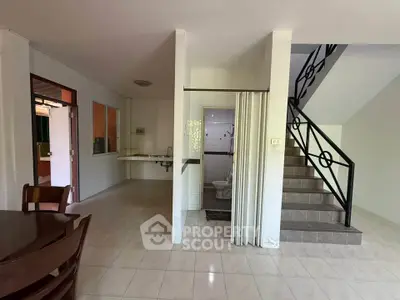 Spacious open-plan living area with staircase and dining space, ideal for modern family living.