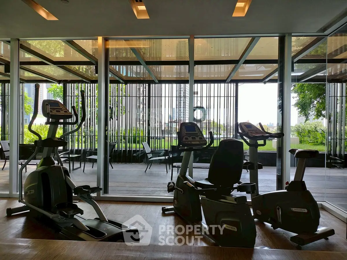 Modern gym with exercise bikes and scenic outdoor view