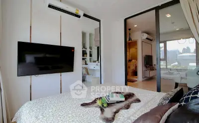 Modern bedroom with TV and air conditioning, featuring a cozy bed and stylish decor.