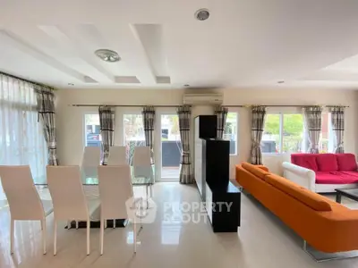 Spacious modern living room with stylish furniture and large windows