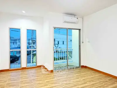 Bright and airy living room with large windows and balcony access in modern home.