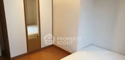 Cozy bedroom with minimalist wardrobe and comfortable mattress