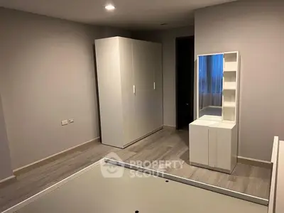 Spacious bedroom with modern wardrobe and sleek vanity unit, perfect for stylish living.