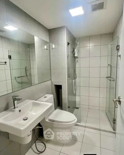 Modern bathroom with sleek fixtures and glass shower enclosure