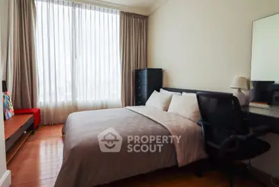 Modern bedroom with large window and stylish furnishings