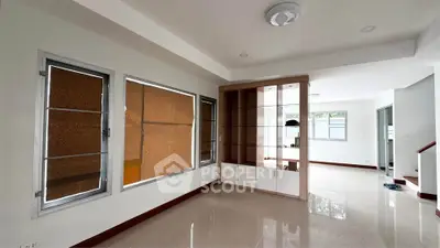 Spacious modern living room with built-in shelving and large windows