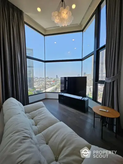 Luxurious corner unit living room with panoramic city views and modern furnishings.