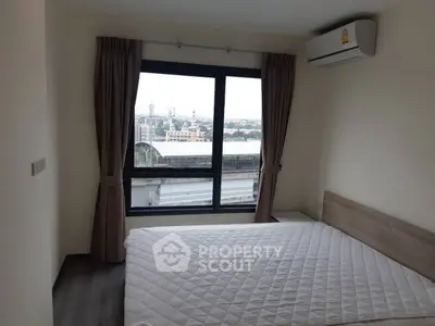 Modern bedroom with city view and air conditioning in high-rise apartment