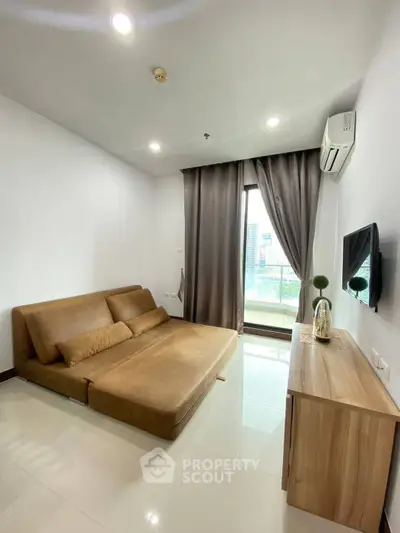 Modern living room with sleek furniture and city view, featuring a cozy sofa and wall-mounted TV.