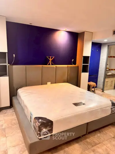 Spacious bedroom with modern design and luxurious bed in a stylish apartment.