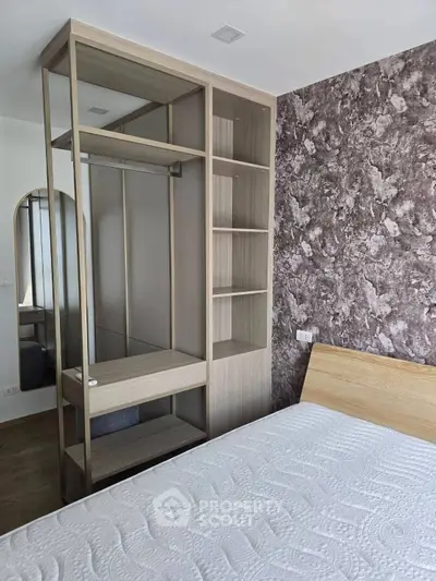 Modern bedroom with stylish open wardrobe and textured accent wall