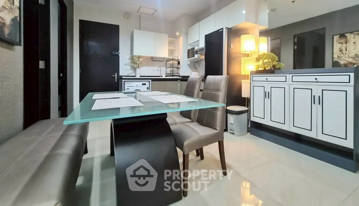 Modern dining area with glass table and stylish chairs in a contemporary apartment.