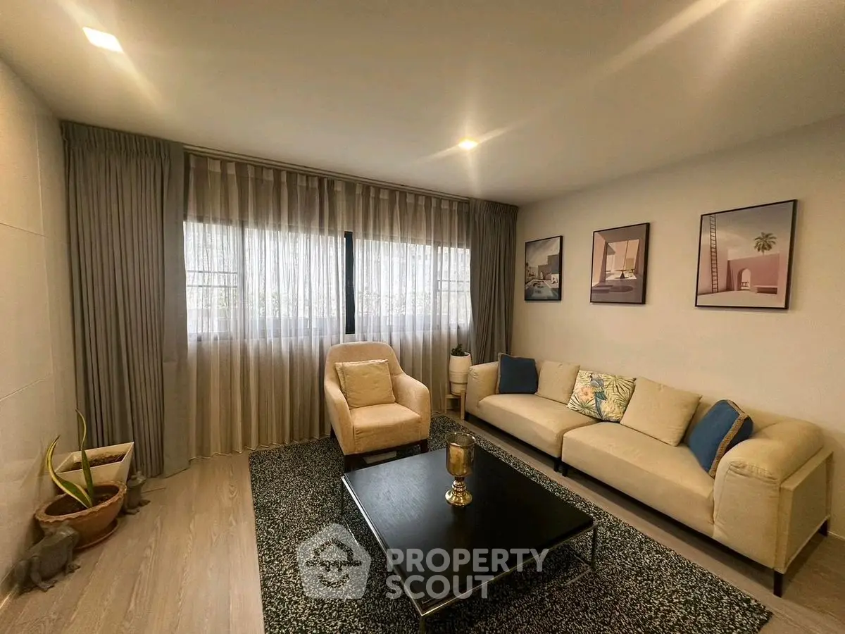 Stylish living room with modern decor and cozy seating area, perfect for relaxation.