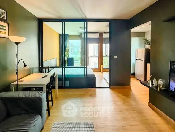 Modern open-plan living room with glass partition and stylish decor