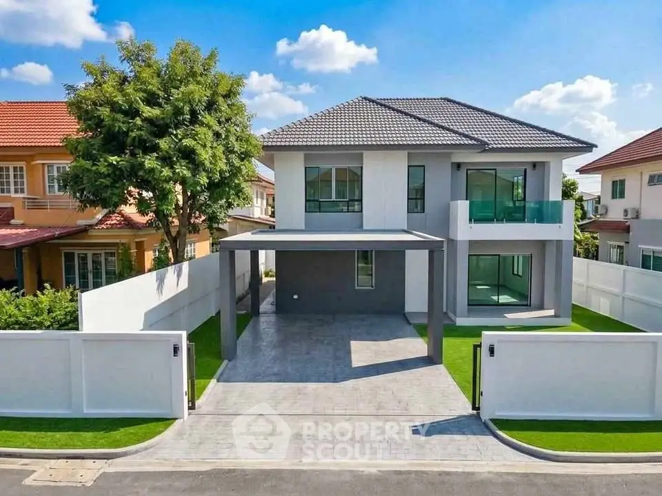 Modern two-story house with spacious driveway and lush greenery in a suburban neighborhood.