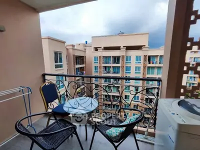 Charming balcony with seating and city view, perfect for relaxation and enjoying the skyline.