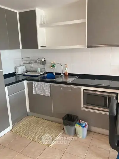 Modern kitchen with sleek cabinetry and built-in microwave