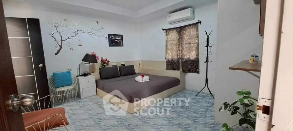Cozy bedroom with modern decor and air conditioning, perfect for relaxation.