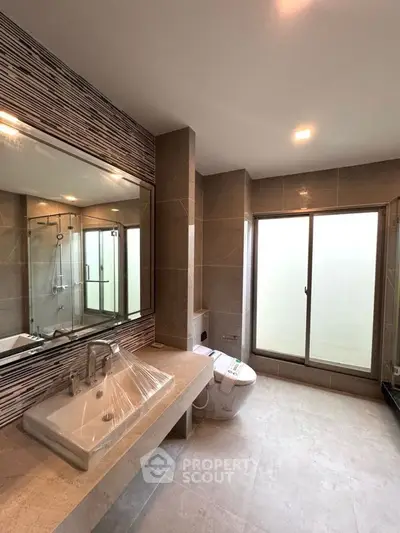 Luxurious modern bathroom with large mirror and sleek fixtures