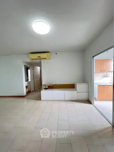 Spacious living room with modern air conditioning and sleek tile flooring