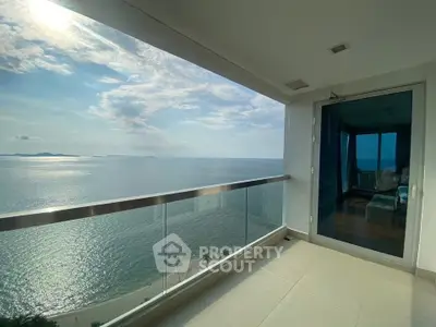Stunning ocean view from modern balcony in luxury beachfront property.