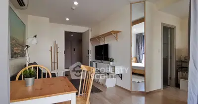 Modern apartment interior with open living and dining area, featuring stylish furniture and natural light.