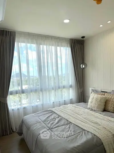 Bright and cozy bedroom with large window and elegant curtains