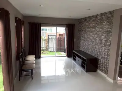 Spacious living room with modern decor and large windows for natural light.