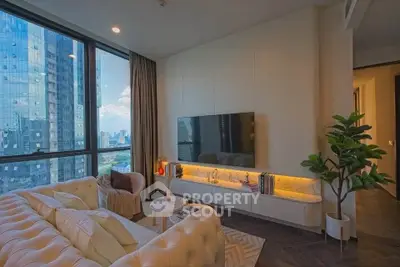 Luxurious living room with city view, modern decor, and large windows in high-rise apartment.