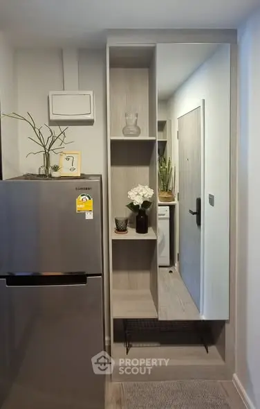 Modern kitchen with sleek fridge and stylish shelving unit