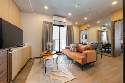 Modern living room with stylish decor and large window in a contemporary apartment.